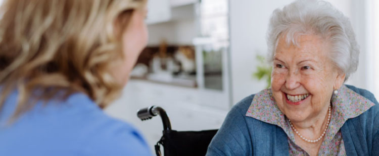 Skilled nursing resident smiling with caregiver | Presbyterian Village Athens